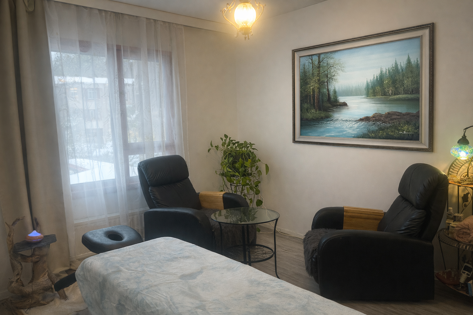 Rauhallinen hoitohuone, jossa on hoitopöytä, kaksi tuolia ja seinällä jokimaisemataulu. Rauhallinen hoitohuone, jossa on hoitopöytä, kaksi tuolia ja seinällä jokimaisemataulu.